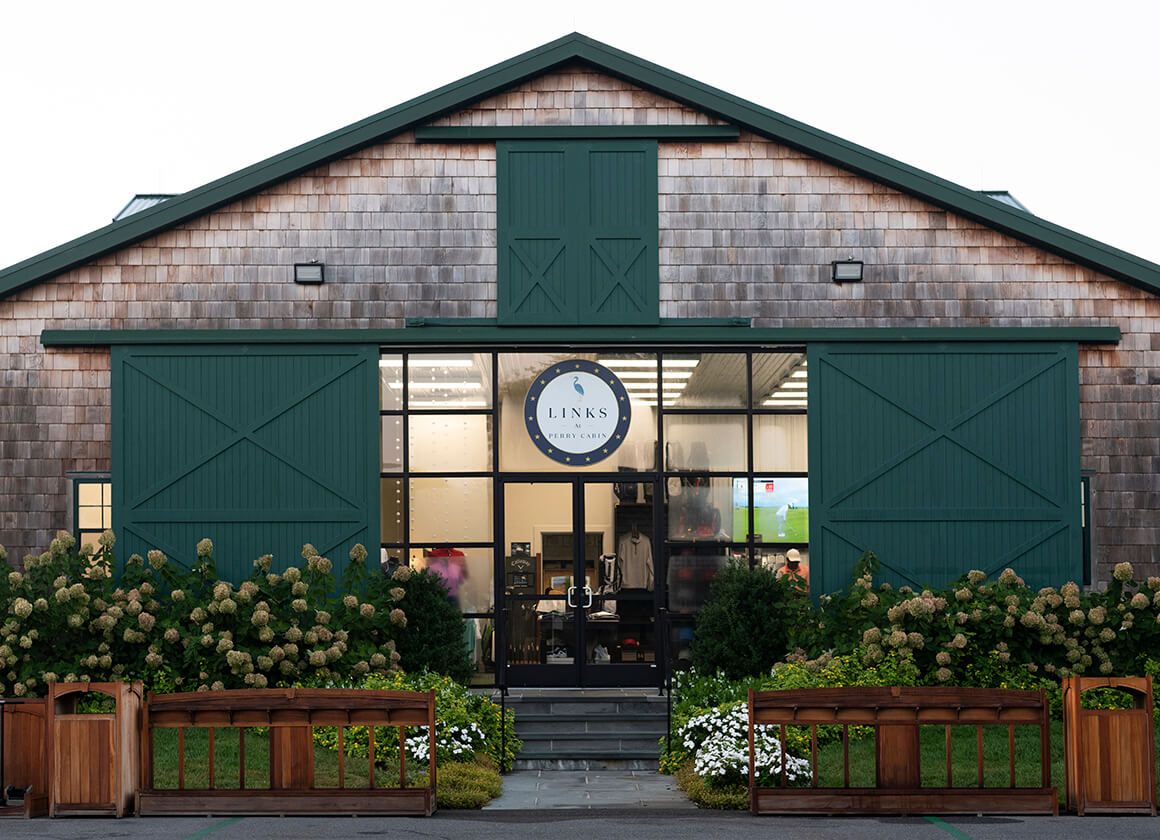 cedar shingled building with green doors