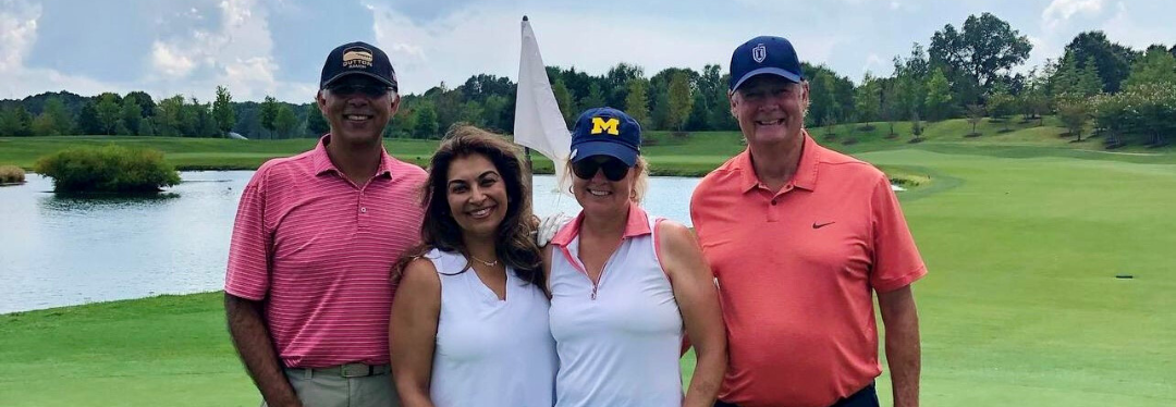 group of golfers pose for picture on the course