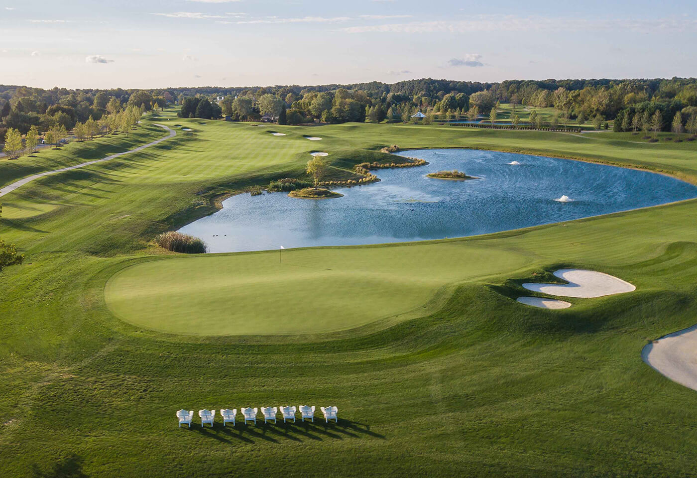 aerial view of golf course and pond