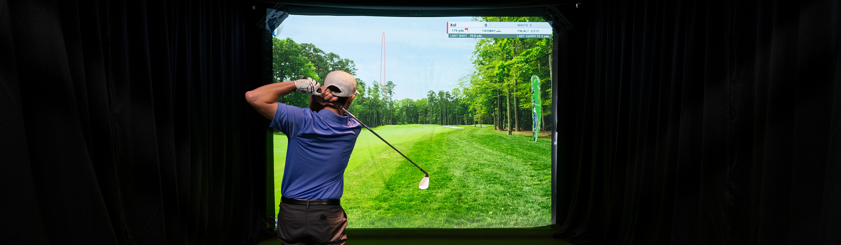 golfer utilizing golf simulator